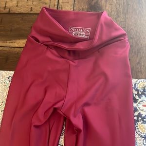 Selling New obsession Leggings. They are XS and burgundy red.